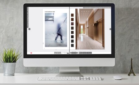 Desktopcomputermonitor met afbeelding van een interactieve catalogus met pagina's met glas- en oppervlakteafwerkingen.
