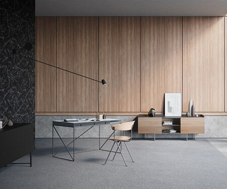 Interieur van een minimalistisch ingerichte, moderne kamer met wanden afgewerkt met 3M DI-NOC Architectural Finishes met zwart marmer, beton en een middenkleur hout.
